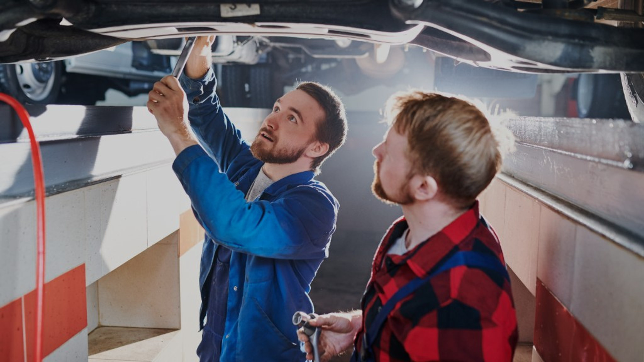 Technician carrying out underbody inspection work in the Euro Car Centre workshop